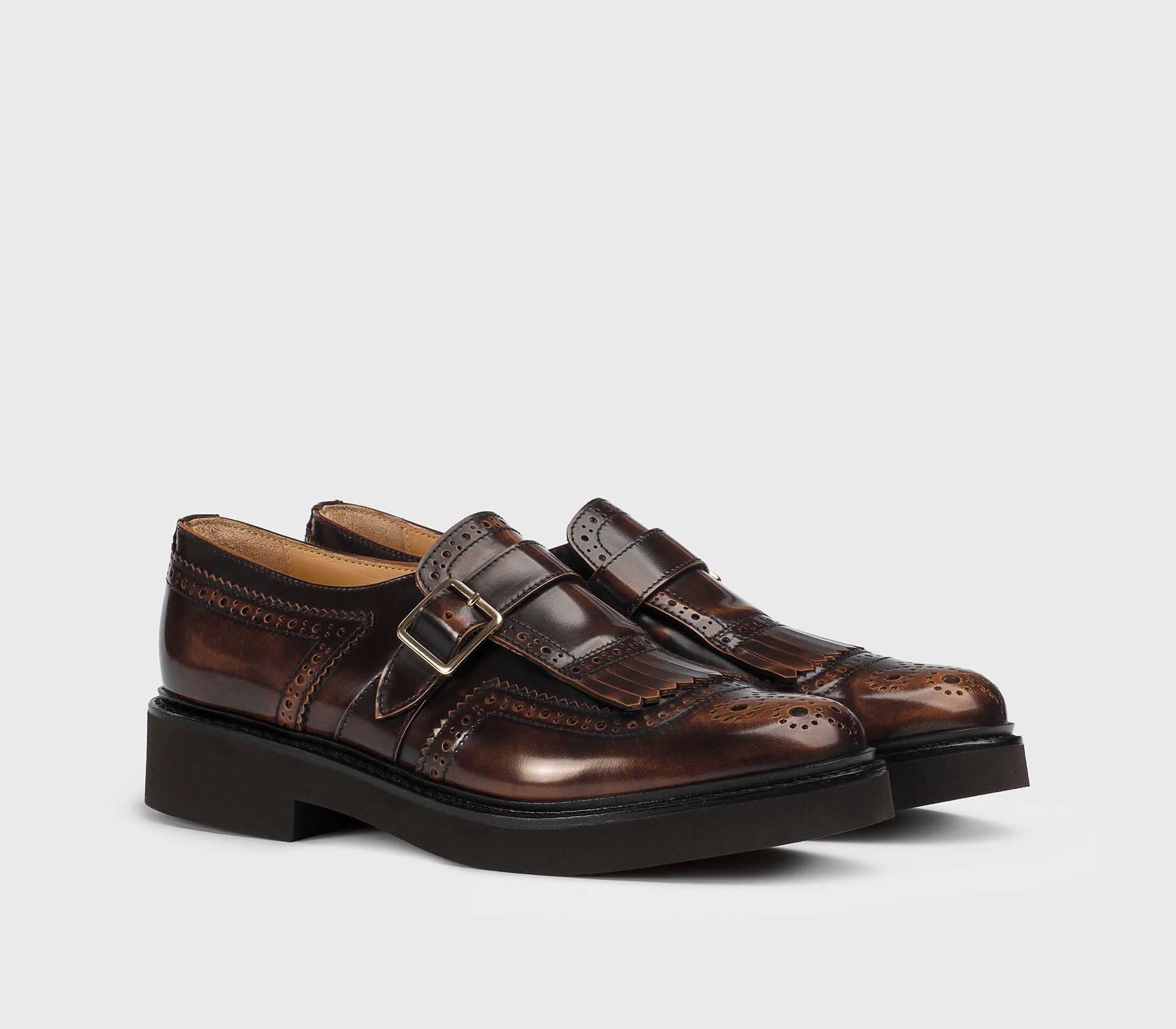 Tan-coloured leather single-buckle shoe with fringing