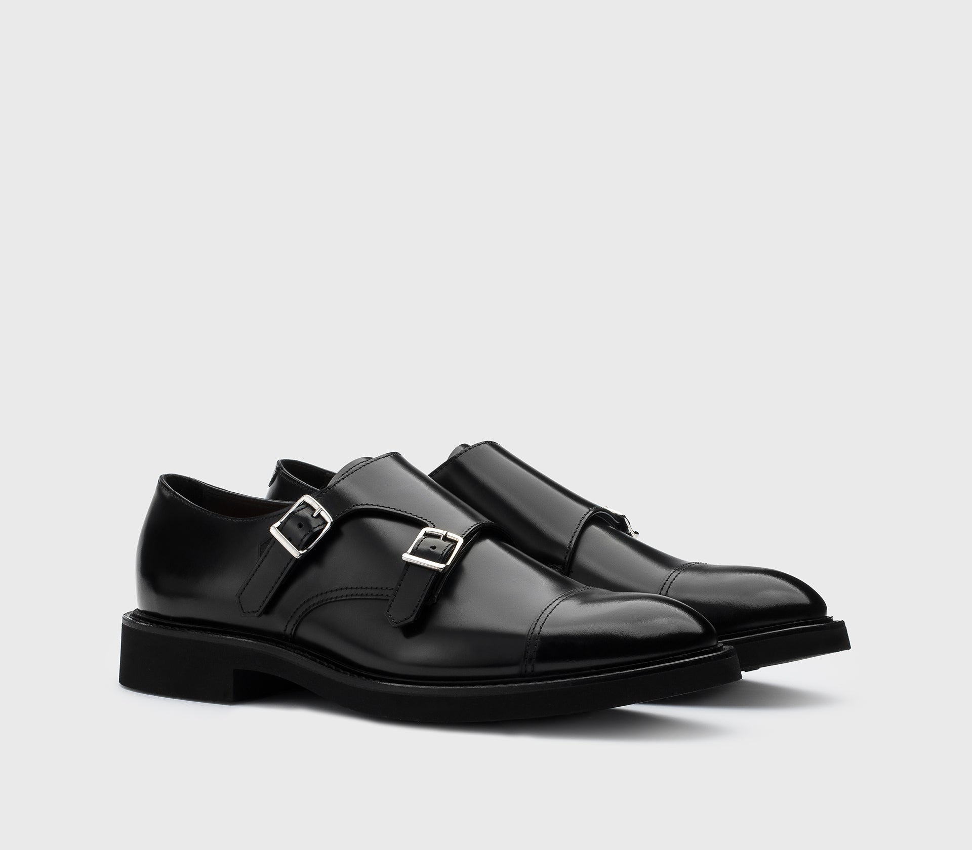 Black leather double-buckle shoe.