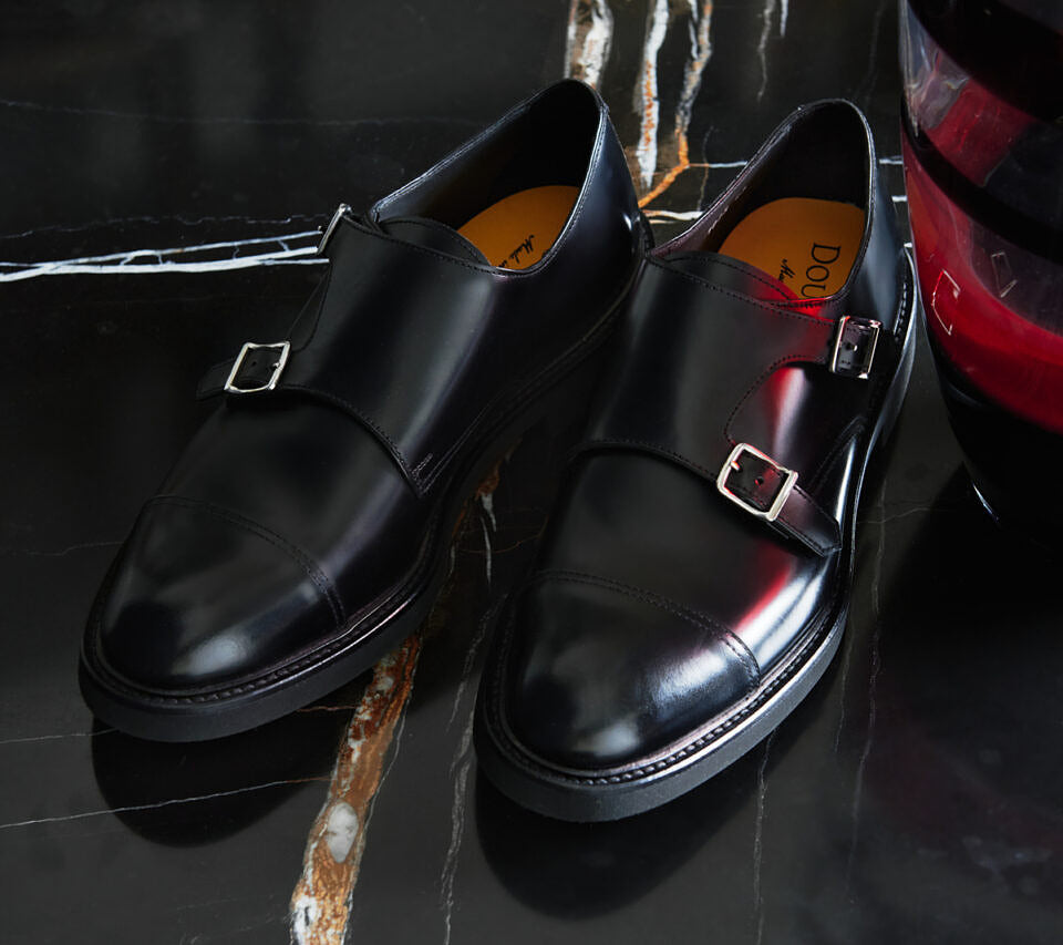 Black leather double-buckle shoe.