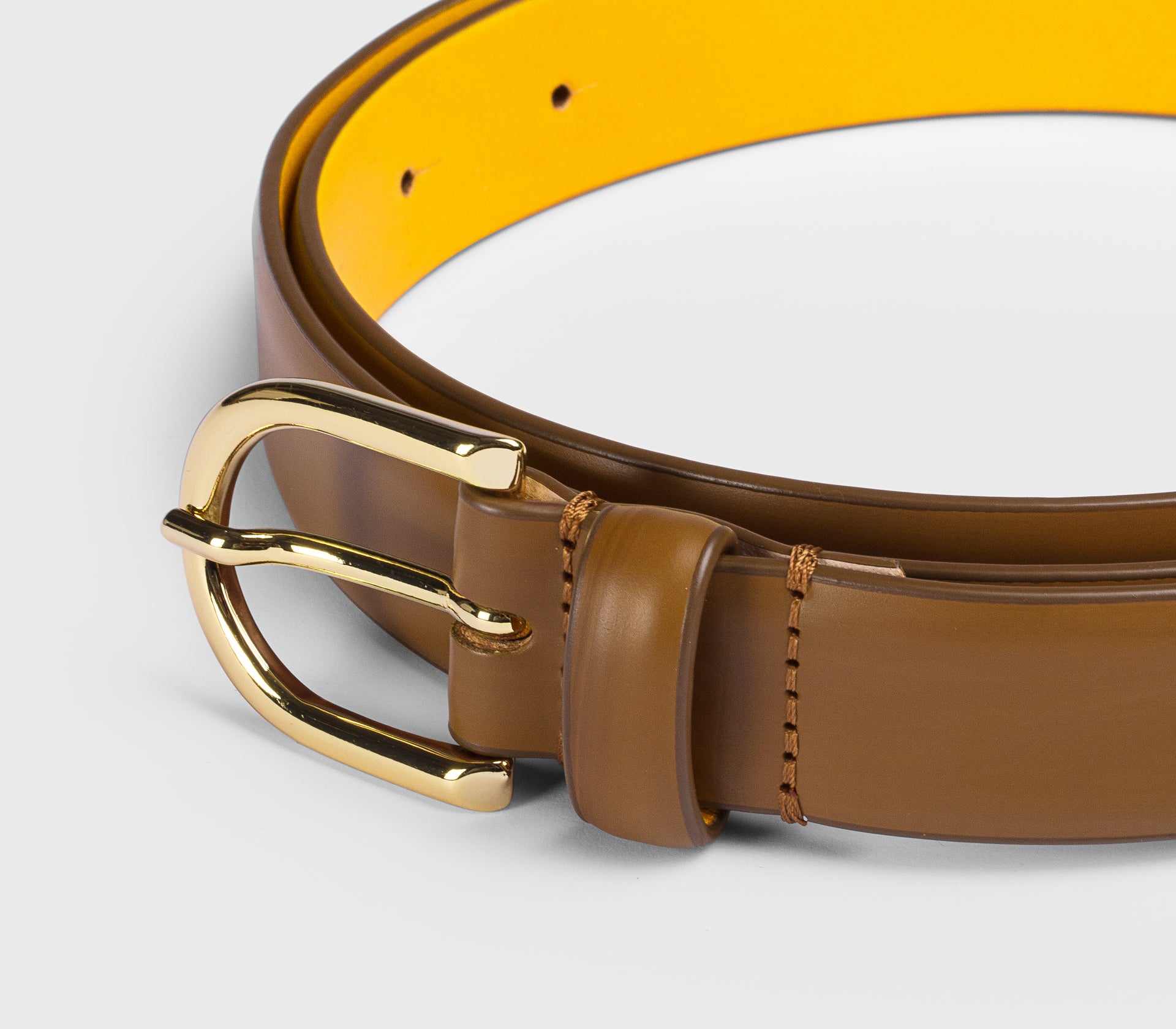 Tan leather belt with “D” buckle