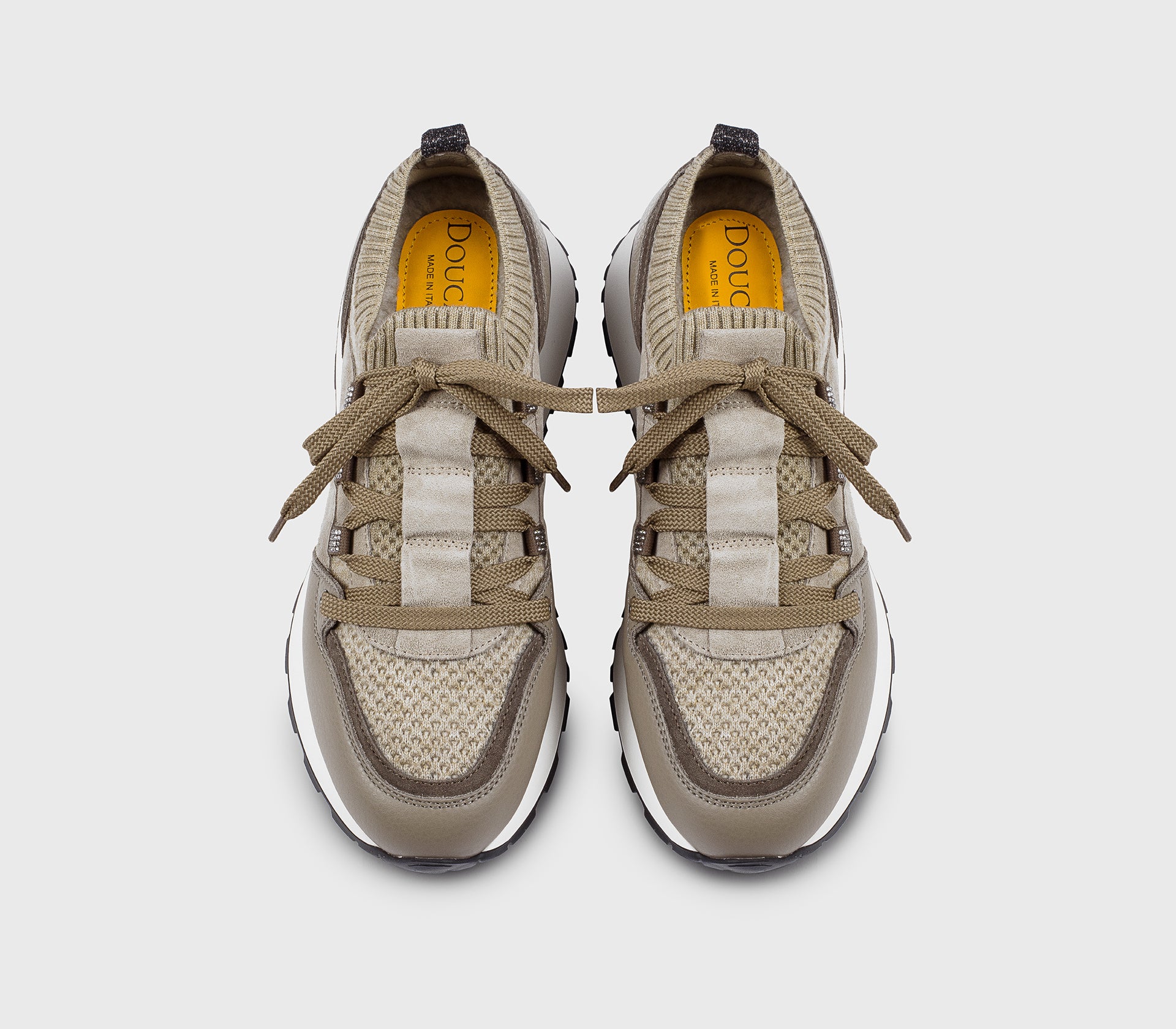 Beige sneaker made from a combination of materials