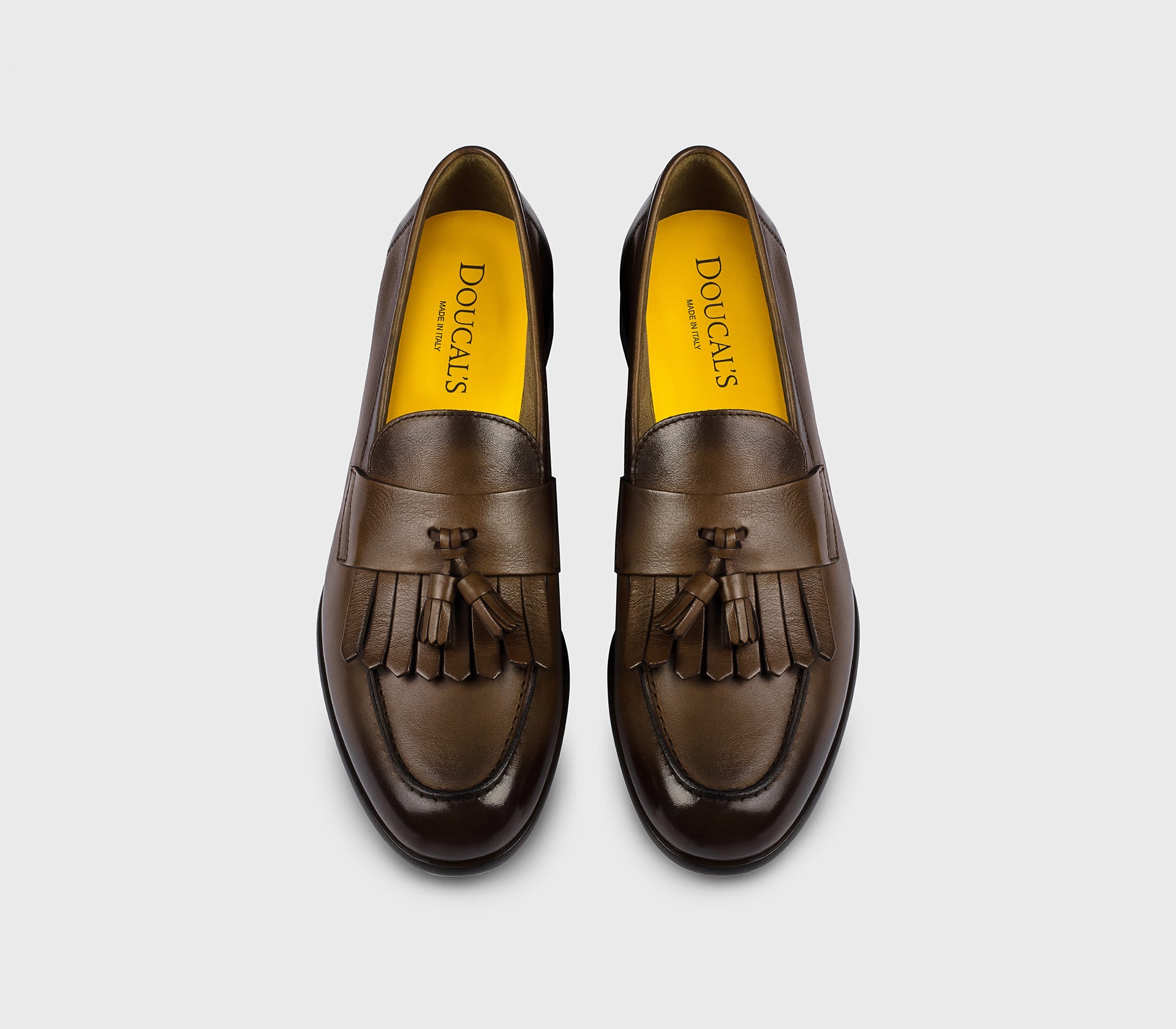 Brown leather loafer with tassels and fringe