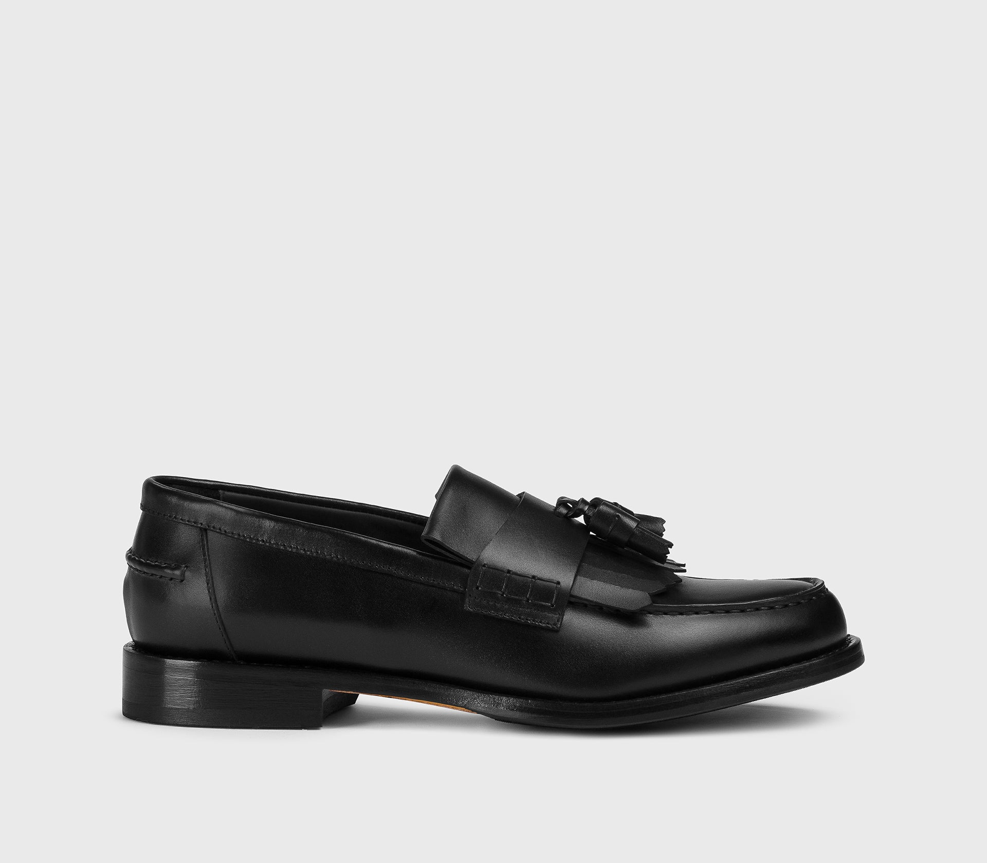 Black leather loafer with tassels and fringe