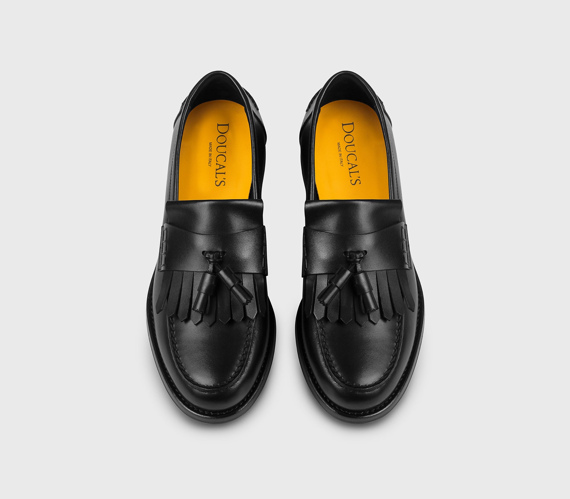 Black leather loafer with tassels and fringe